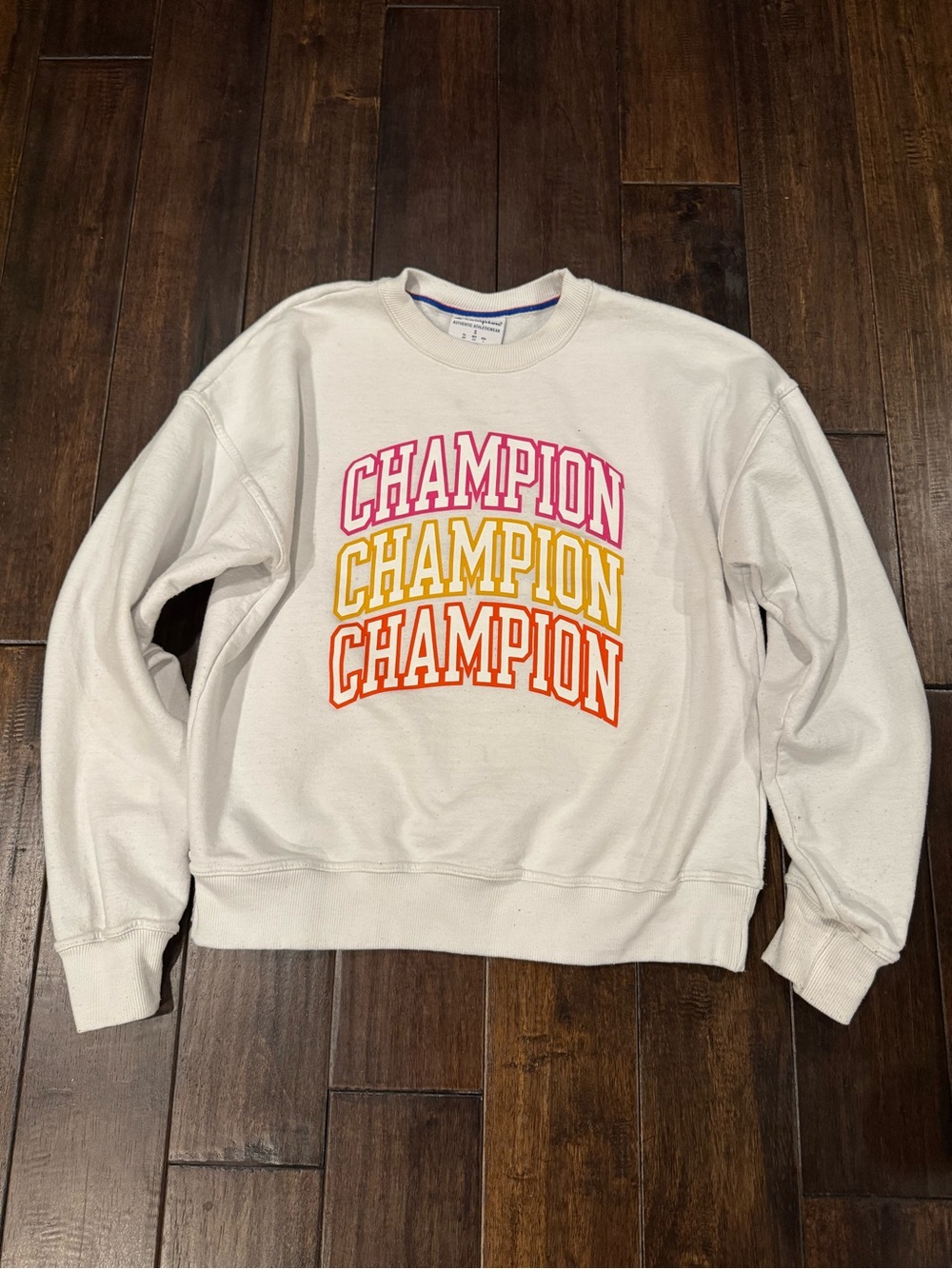 Champion white crewneck sweatshirt with orange and pink accents. Size S